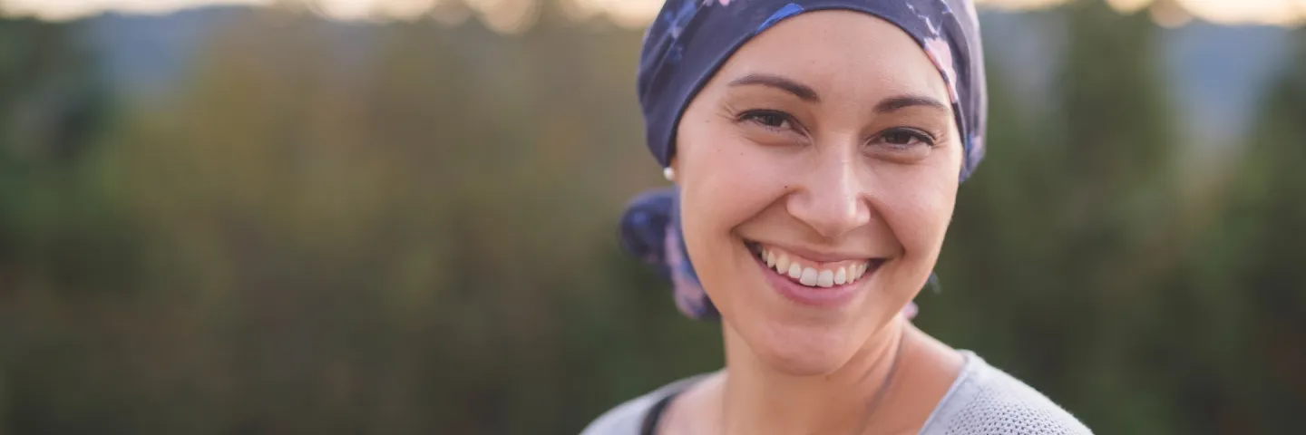 Young woman wearing a headscarf smiling to the camera