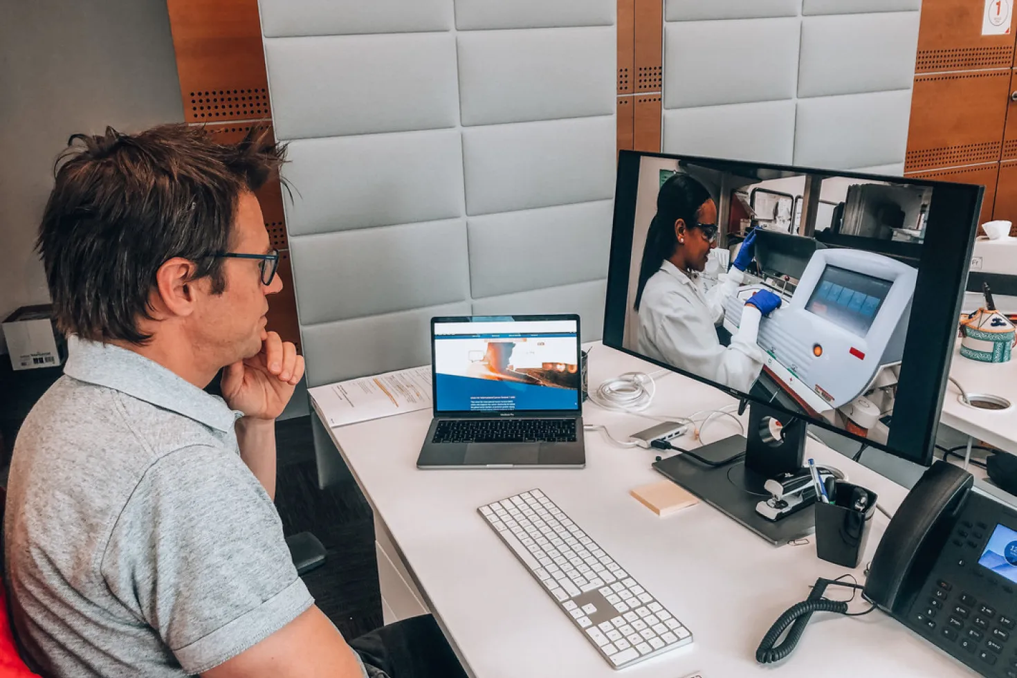 a man looking at his computer at a desk