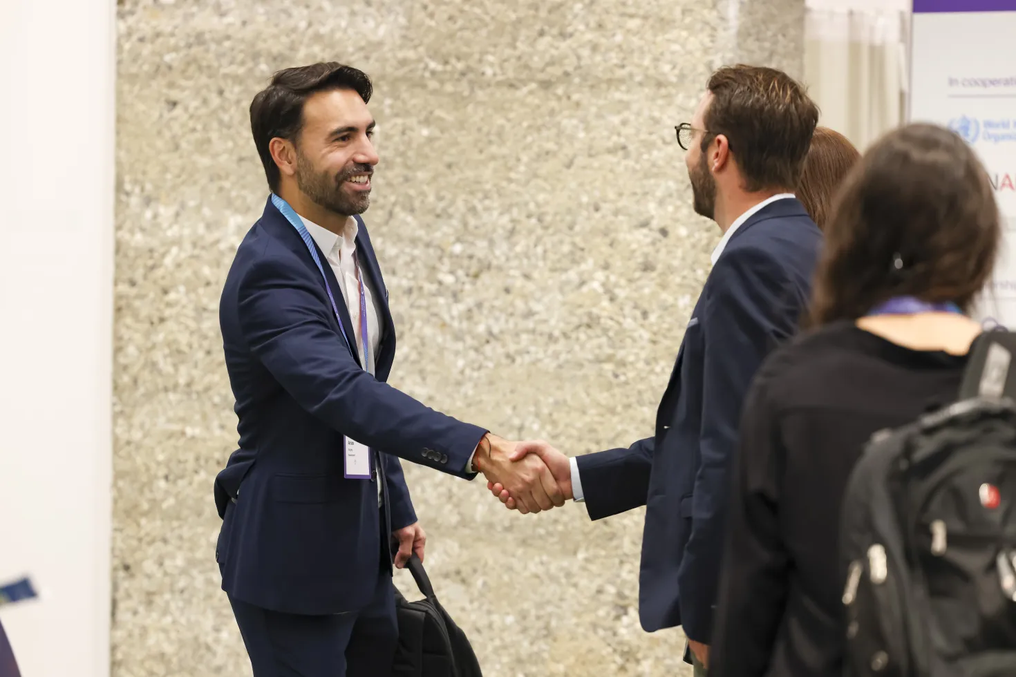 Two men shaking hands and smiling
