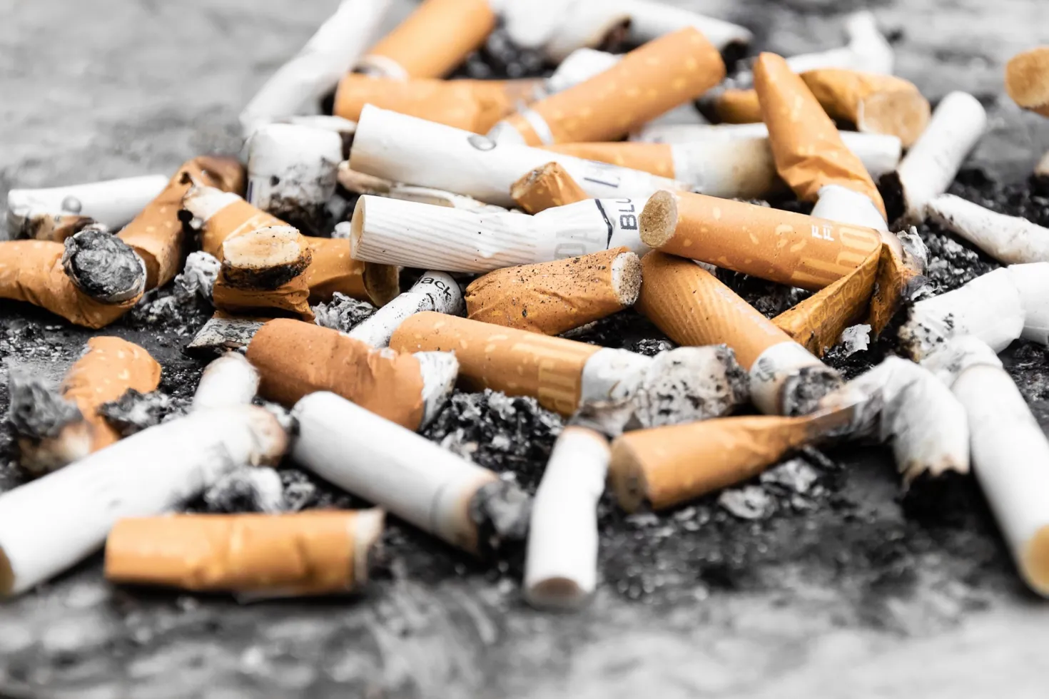 Used cigarette butts polluting the ground