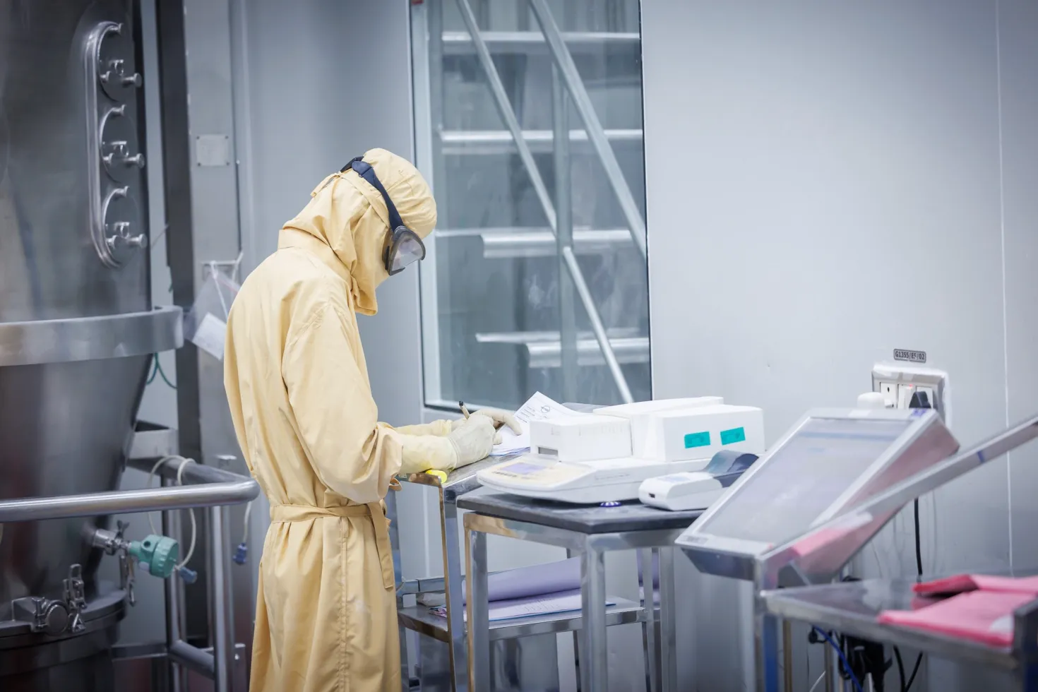 Man in yellow hazmat suit in a lab
