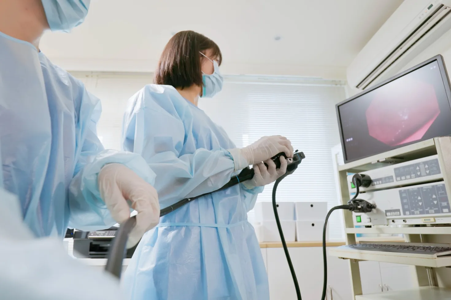 Closeup low angle view asian physician colonoscopy to patient in the clinic with nurse assistance - cancer related examinations