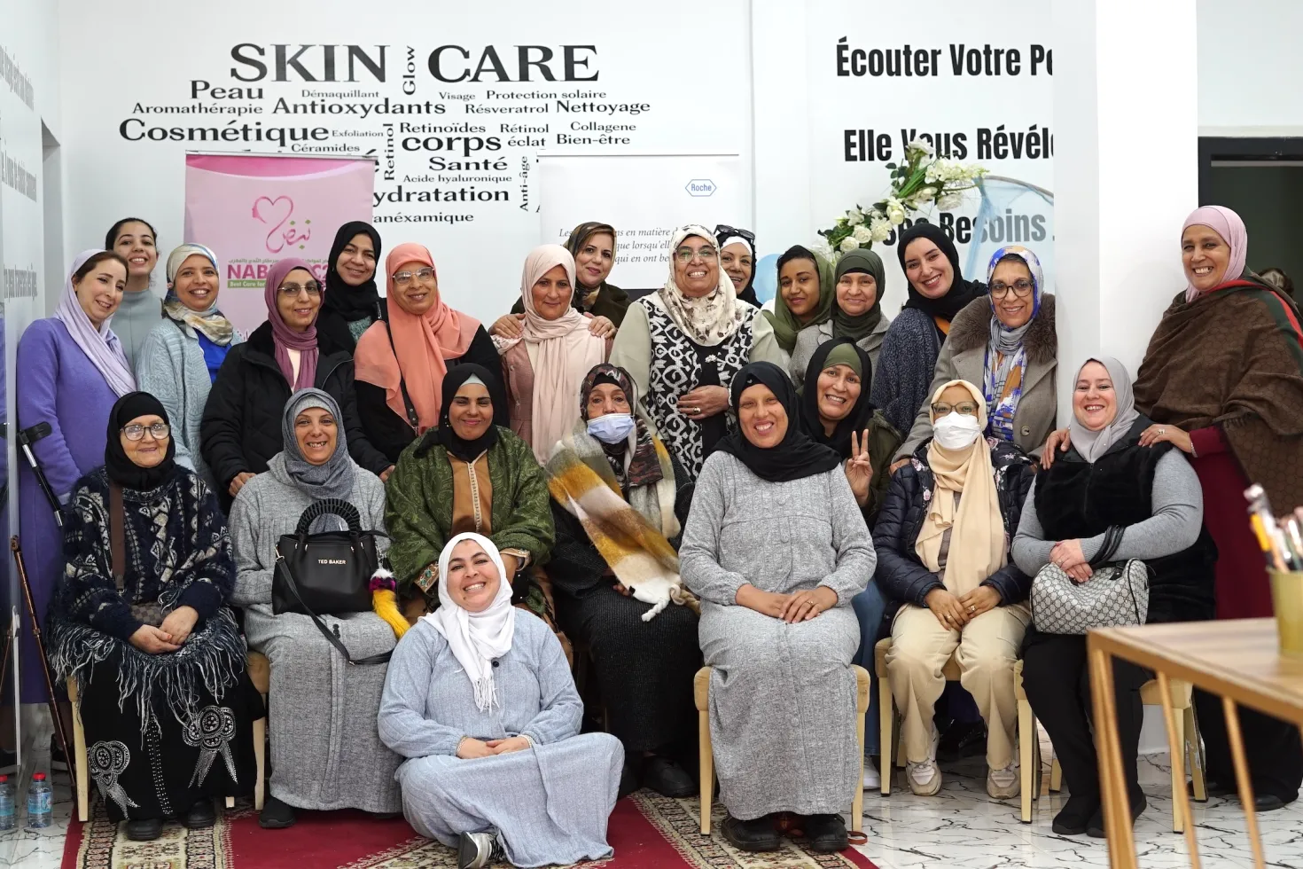 Group of Middle Eastern women smiling, part of a cancer patient organisation
