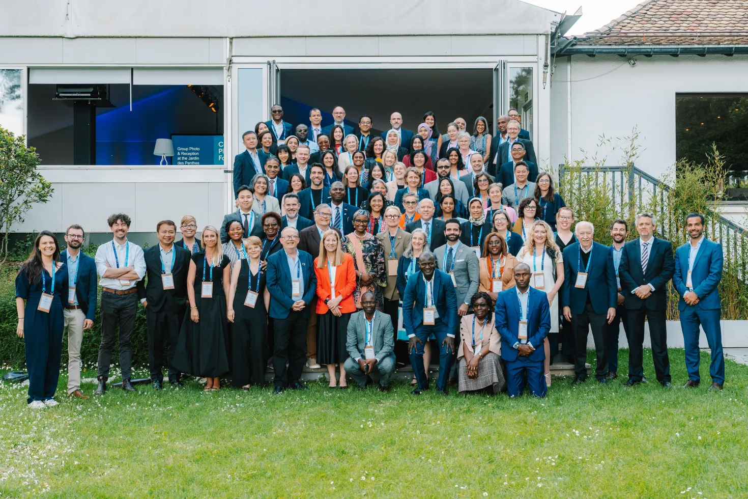 Diverse group of participants in a seminar posing outside a building