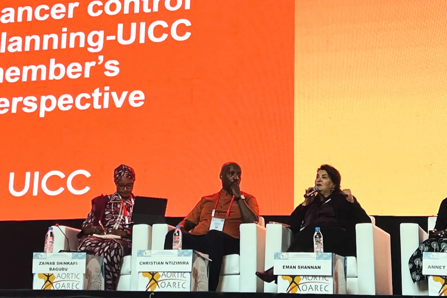 Four diverse panelists in front of a branded screen for UICC