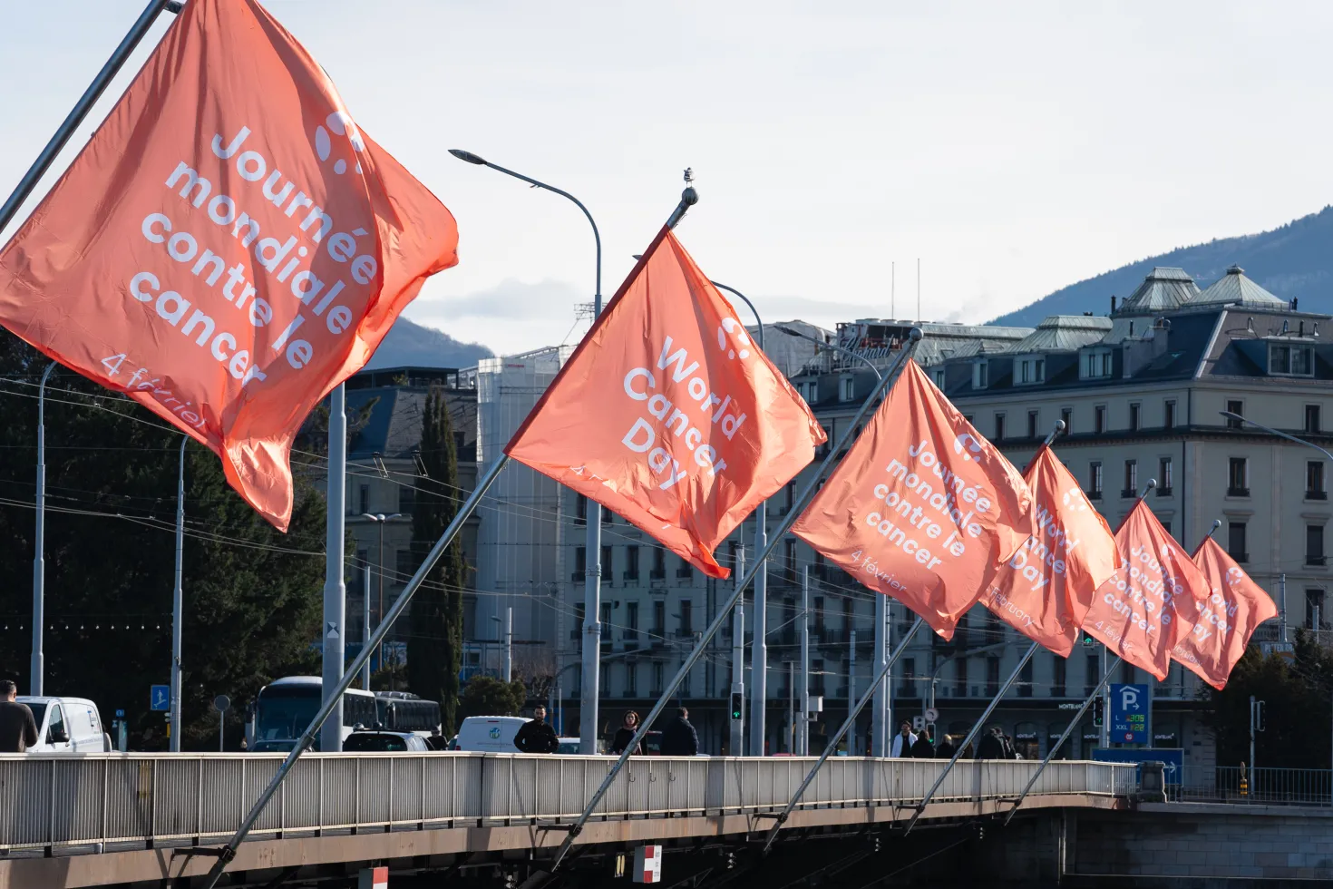 Row of branded World Cancer Day flags on a bridge in Geneva, Switzerland