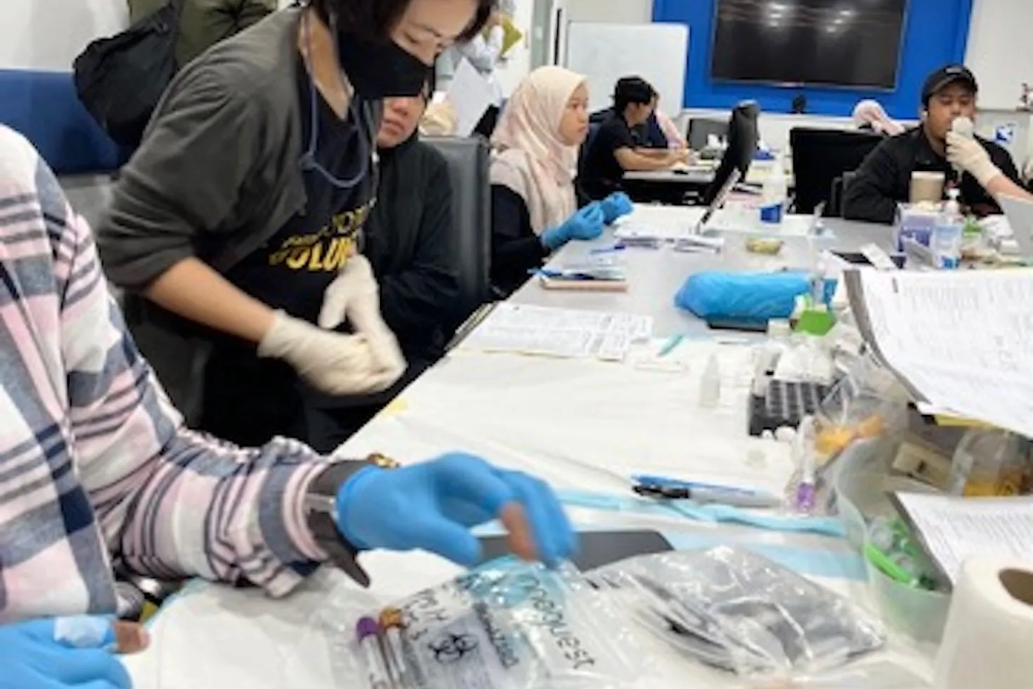 Asian women providing cancer screening in a beauty salon