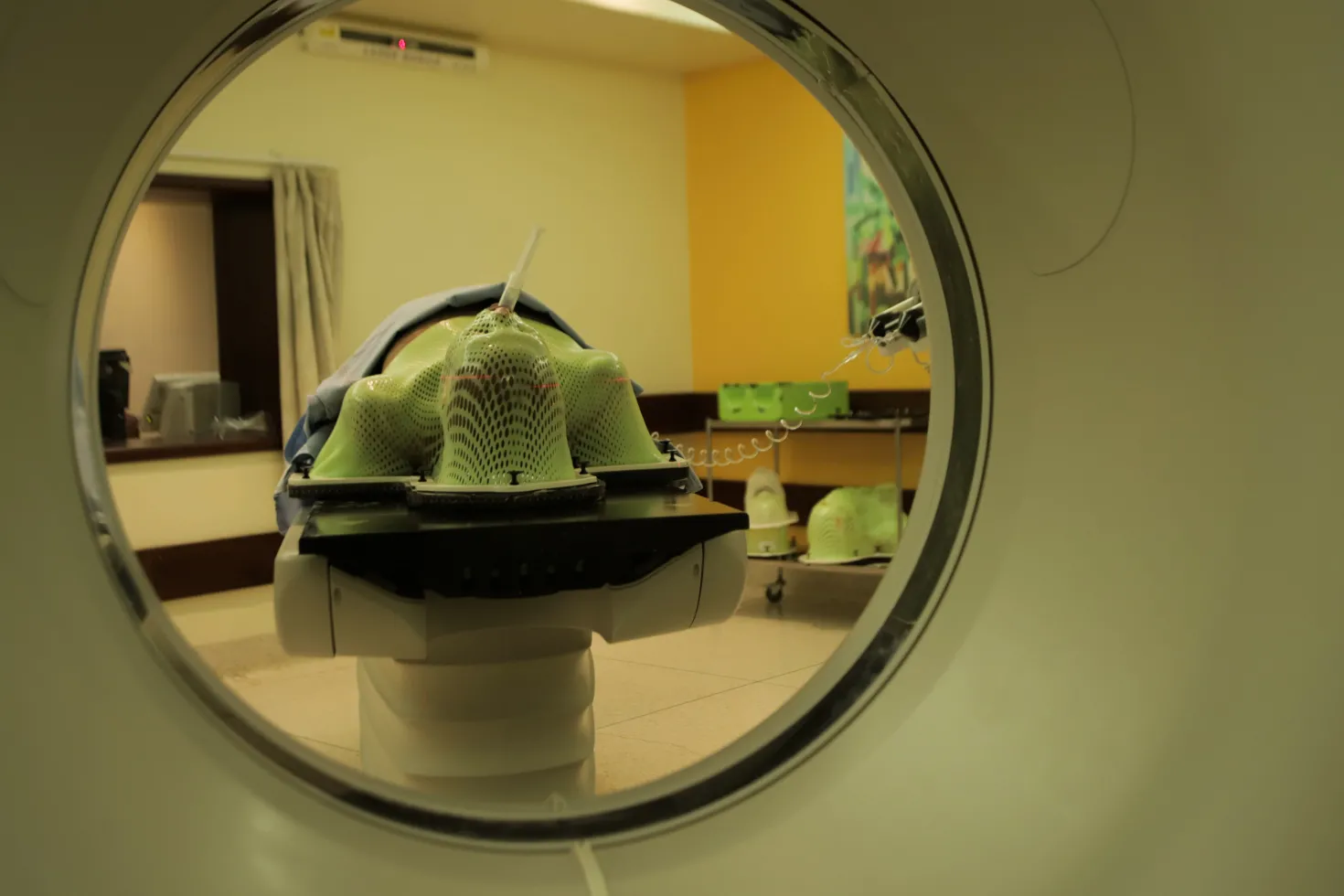 View of a person about to enter a radiation therapy machine, seen from within the machine