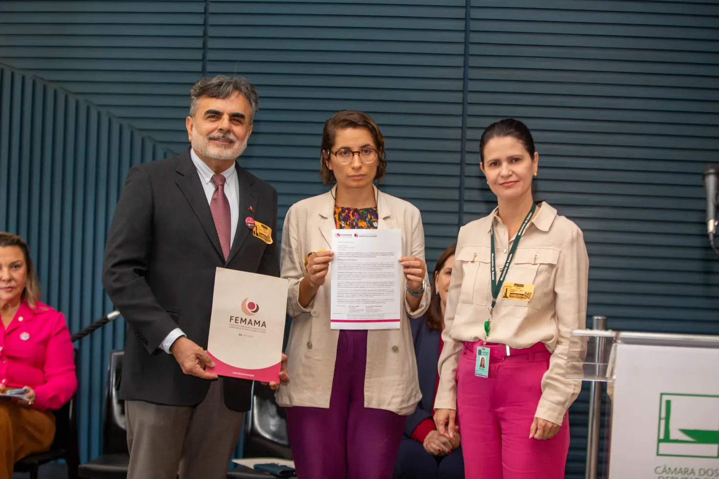 Latin American man and two women receiving a prize