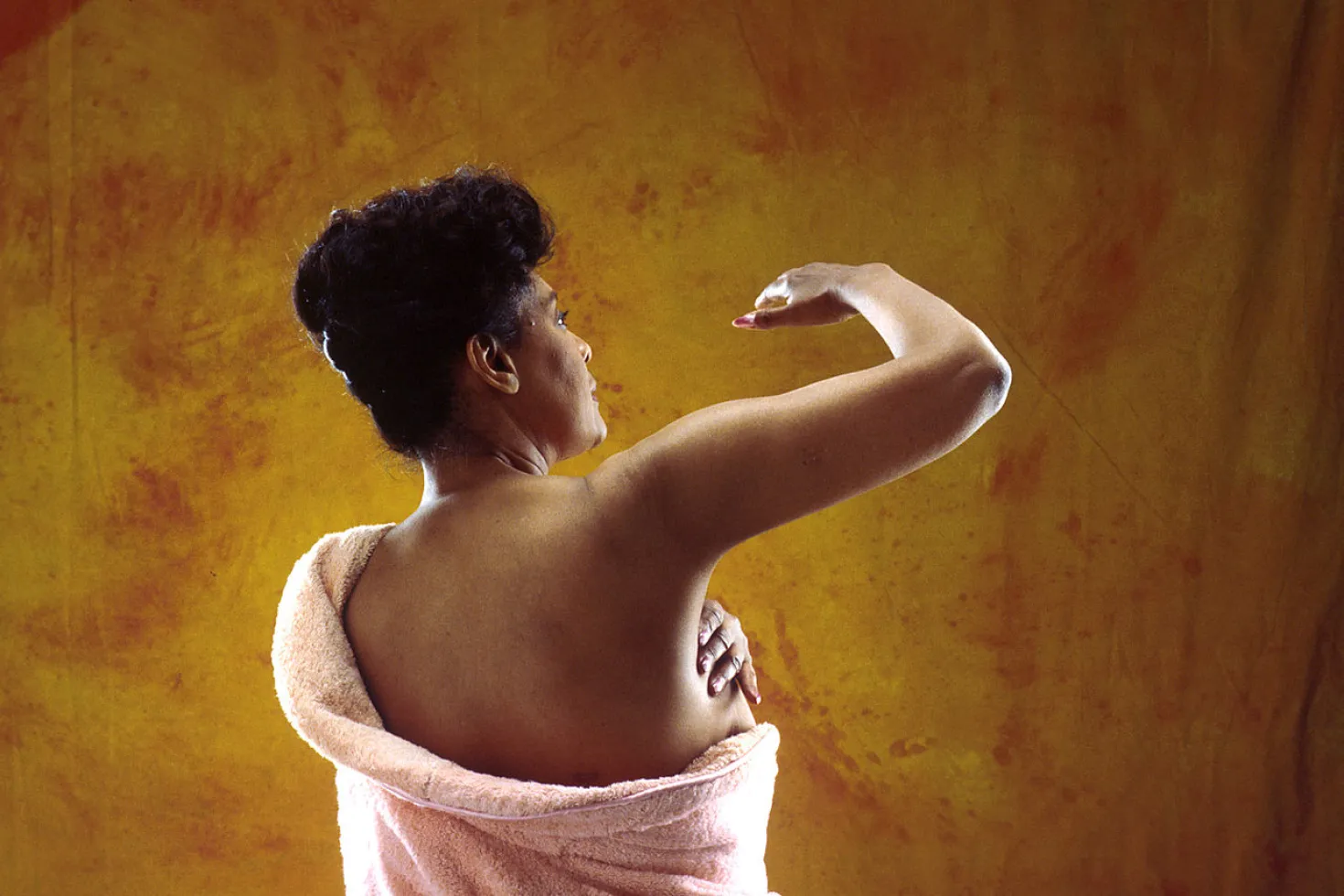 Woman self-examining her breast