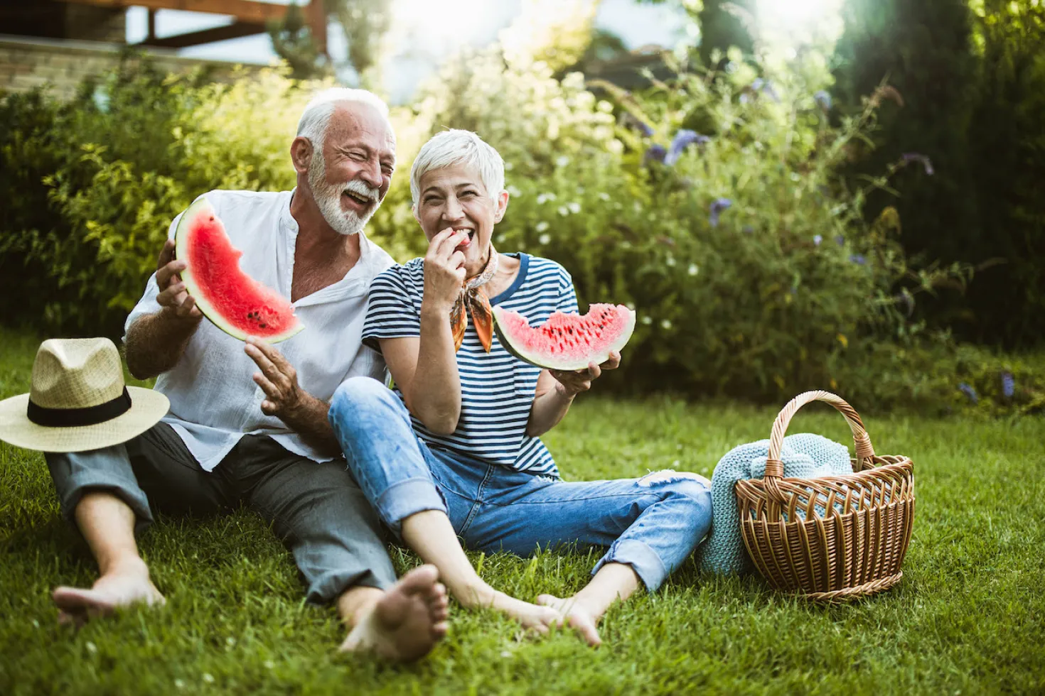 SwissRe CMO Dr John Schoonbee highlights six behaviours each person can act on to positively impact their health and help prevent cancer: sleep, physical activity, nutrition, substance use, mental wellbeing and their environment. Elderly couple eating watermelon symbolising a healthier lifestyle through nutrition