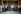Diverse group of people standing in rows on a staircase, the TNM Core Committee