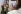 Young blond haired women showing a picture of her doing the World Cancer Day upside down challenge while a colleague films for FujiFilms