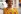 Headshot of an African woman with yellow top