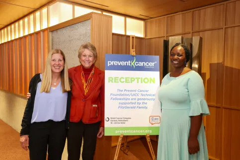Women posing at the entrance of a conference