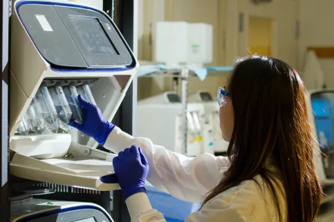 Technician prepares for a viral whole-genome sequencing experiment at the Cancer Genomics Research Laboratory, part of the National Cancer Institute's Division of Cancer Epidemiology and Genetics (DCEG)