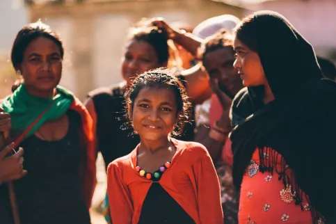 Group of Asian women of different ages, with young girl smiling at the camera