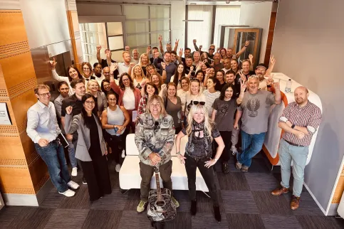 Mike Peters, front man for The Alarm, withi his wife Jules Peters at his side and surrounded by members of Love Hope Strength and UICC staff in the lobby of UICC offices in Geneva