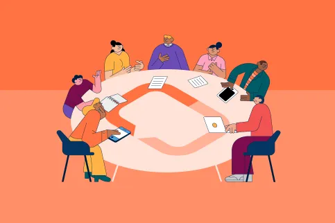 People sitting around a round table adorned with UICC's logo