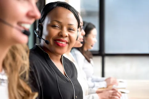 Black women with headset looking into the camera