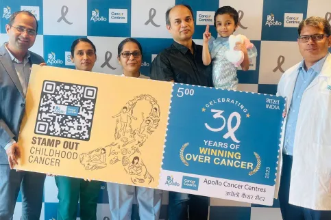 Apollo Hospital staff holding up a large banner celebrating 30 years of addressing cancer