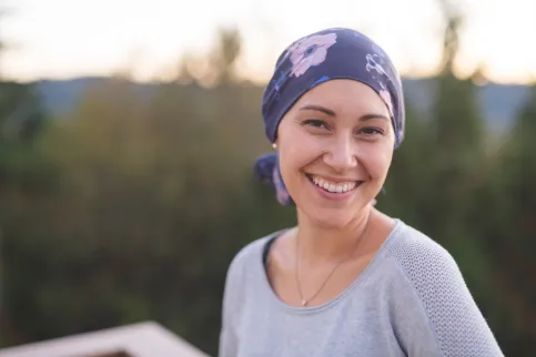 Young woman wearing a headscarf smiling to the camera