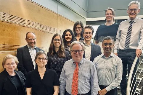 Diverse group of people standing in rows on a staircase, the TNM Core Committee