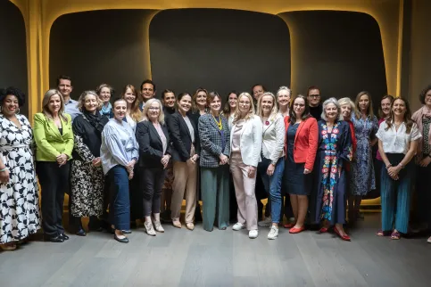 Diverse group of people standing in rows on a staircase, the TNM Core Committee