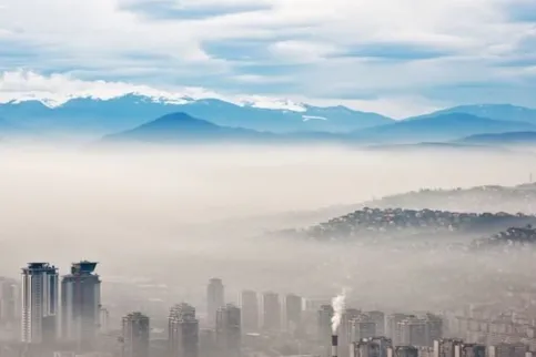 Image of city and mountains covered in smog