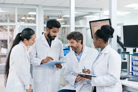 A group of young doctors, two men and two women, of diverse ethnicities