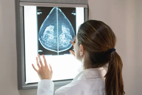 gynocologist looking at a patients mammogram at the hospital