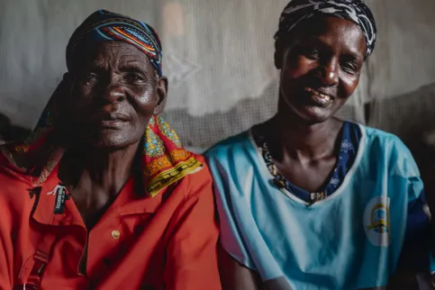 Two African women smiling into the camera, cut at chest