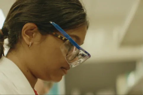 Shoulder-length framed side shot of Asian woman wearing glasses
