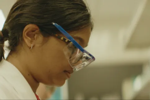 Shoulder-length framed side shot of Asian woman wearing glasses