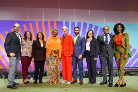 Group photo of nine men and women of diverse background