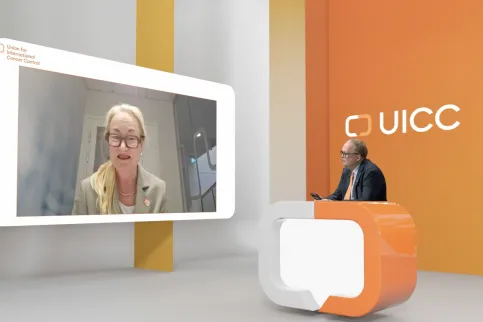 Screenshot of UICC's virtual General Assembly, with Cary Adams in a virtual studio speaking with the new UICC President Ulrika Kagstrom