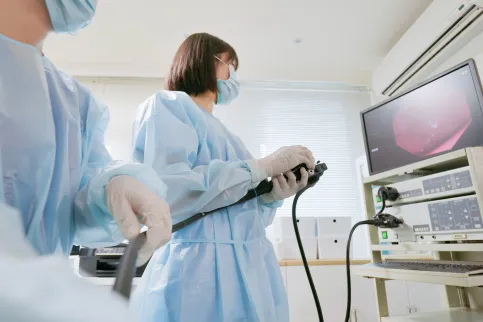 Closeup low angle view asian physician colonoscopy to patient in the clinic with nurse assistance - cancer related examinations