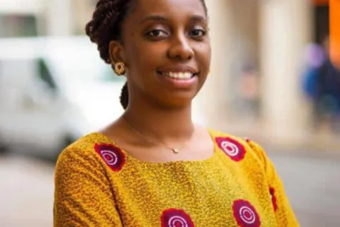 Headshot of an African woman with yellow top