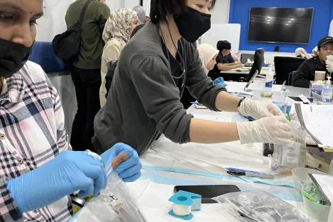 Asian women providing cancer screening in a beauty salon