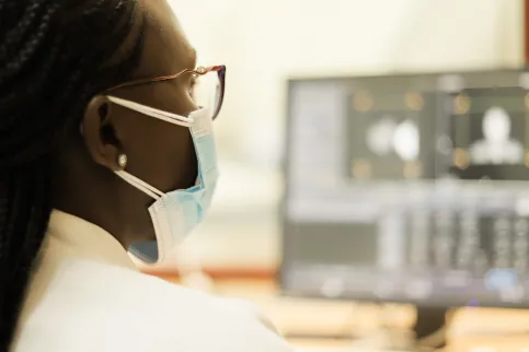 Healthcare professional reviewing medical imaging on a computer workstation at the Aga Khan University in Keyna, illustrating the use of digital technology in cancer diagnosis and treatment planning.