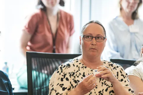 Headshot of a Scandinavian woman with glasses speaking at a conference