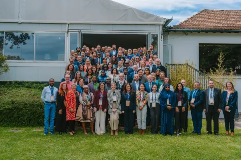 Diverse group of people standing outdoors in front of a pavillion