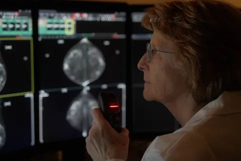 Woman looking an AI analysis of a breast cancer scan