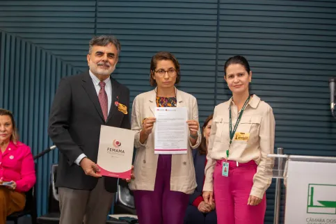 Latin American man and two women receiving a prize
