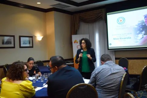Woman speaking at an ATOM Coalition symposium