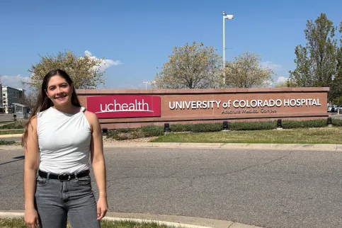 Photo of woman standing in front of University of Colorado Hospital sign