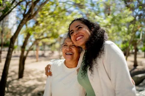 Young and old Asian women hugging