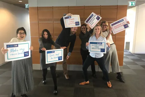 UICC Comms Team holding their "Signs for Change"