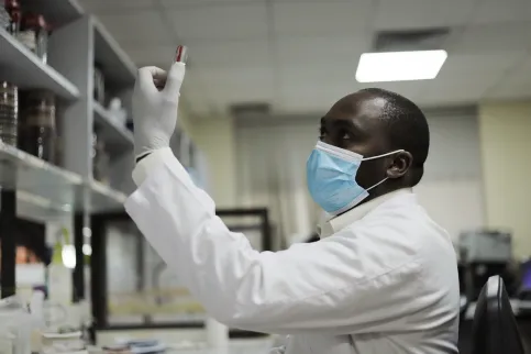 Healthcare worker looking at a sample at the pathology department at the  Aga Khan University Hospital in Kenya