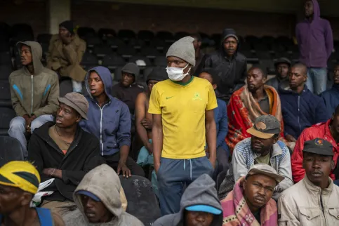 Homeless people stay at the Caledonian stadium downtown Pretoria, South Africa, April 2, 2020, after being rounded up by police in an effort to enforce a 21-day lockdown to control the spread of the coronavirus.